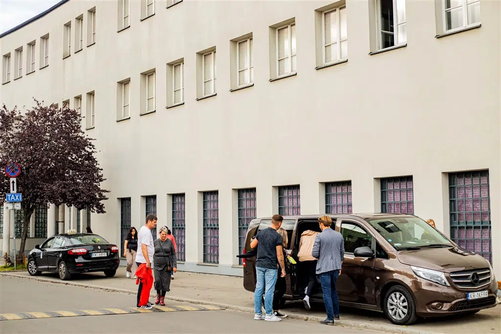 Group of tourists entering a Krakow Direct minibus after a Schindler's Factory tour
